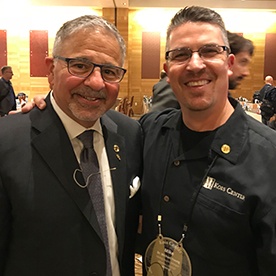 Doctor Young with a man in a suit at a dental conference