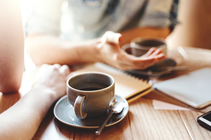 person drinking a cup of coffee